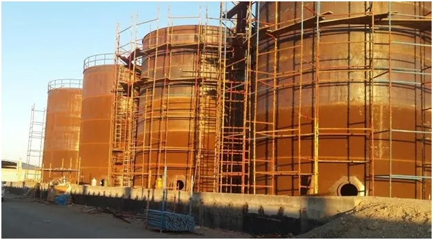 Four palm oil storage tanks — complete.